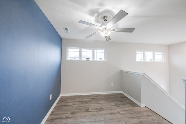 2628 Lamar Dr, Whitestown, IN 46075 - empty room featuring healthy amount of natural light, ceiling fan, and wood finished floors