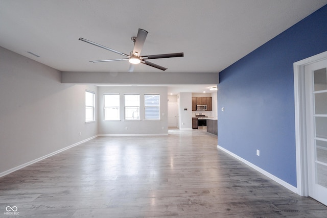 2628 Lamar Dr, Whitestown, IN 46075 - unfurnished living room featuring a ceiling fan and wood finished floors