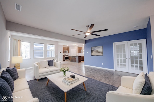 2628 Lamar Dr, Whitestown, IN 46075 - living room with light wood-style flooring, ceiling fan, and french doors