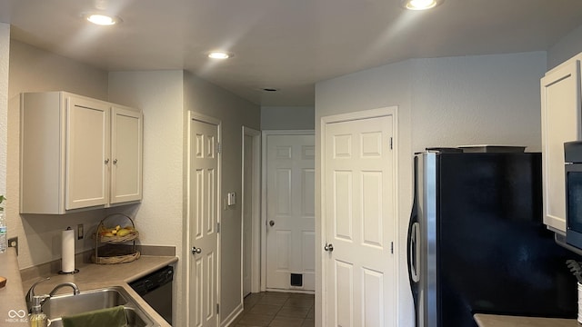 562 Harmony Dr, Greenwood, IN 46143 - kitchen featuring white cabinets, a sink, light countertops, stainless steel appliances, and dark tile patterned flooring