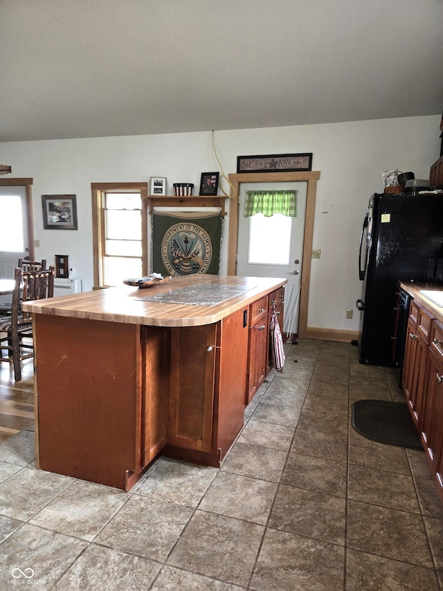 kitchen with butcher block countertops and plenty of natural light