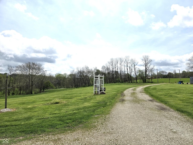 surrounding community featuring driveway and a lawn