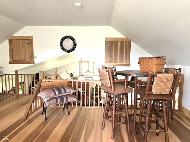 dining area with lofted ceiling and light wood-type flooring