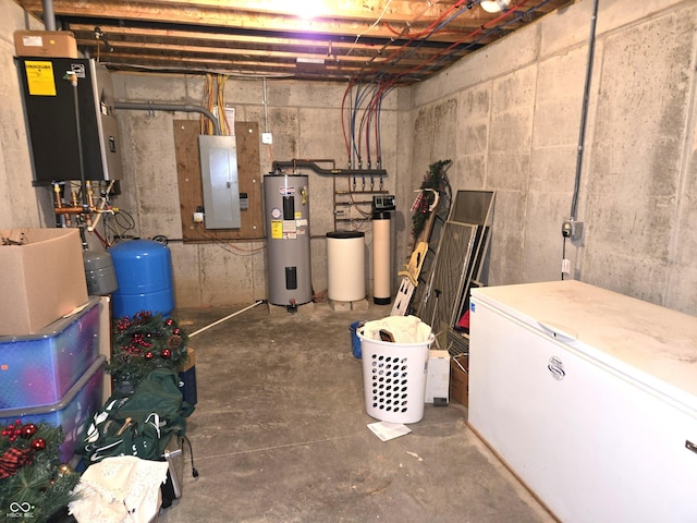 unfinished below grade area featuring electric water heater, white refrigerator, electric panel, and a water pressure tank