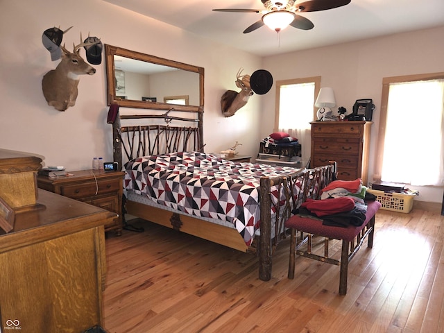 bedroom featuring multiple windows, light wood-type flooring, and ceiling fan