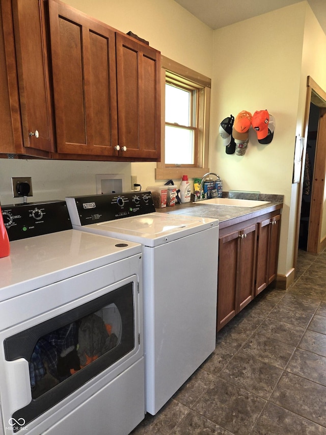 washroom featuring separate washer and dryer and cabinet space