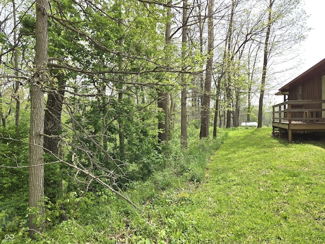 view of grassy yard with a deck