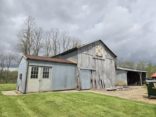 view of barn with a lawn