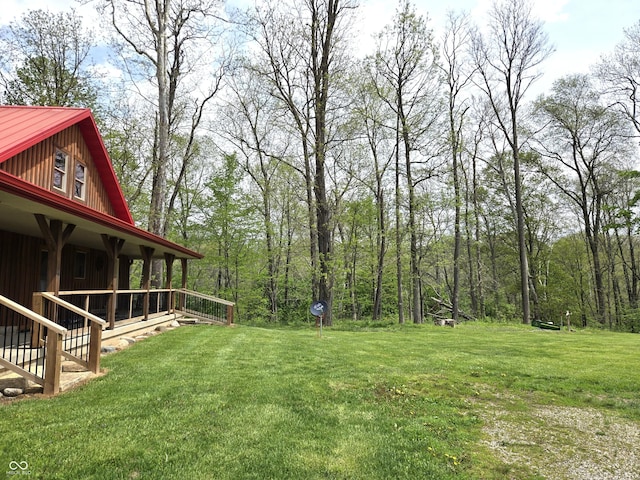 view of grassy yard with covered porch