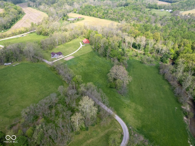 view of property location featuring rural landscape and a heavily wooded area