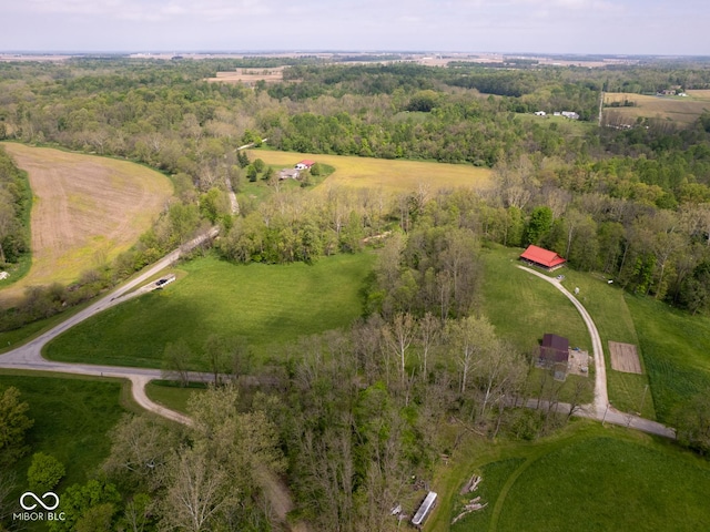 aerial view of property's location featuring rural landscape and a heavily wooded area