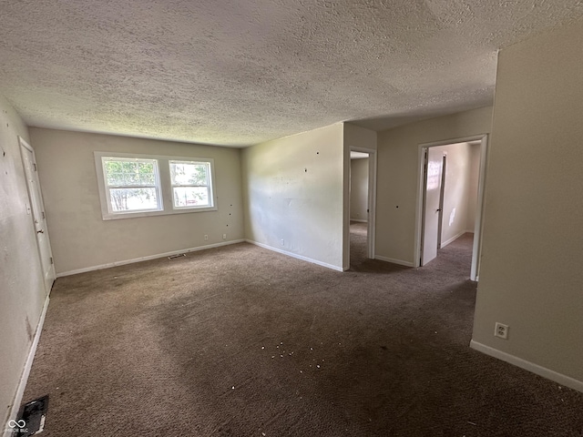 4109 E 21st St, Indianapolis, IN 46218 - spare room featuring a textured ceiling, carpet floors, and baseboards