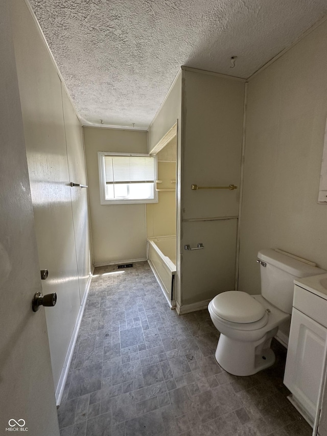 4109 E 21st St, Indianapolis, IN 46218 - full bathroom with toilet, a textured ceiling, baseboards, a tub to relax in, and vanity