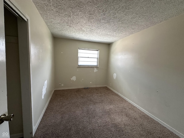 4109 E 21st St, Indianapolis, IN 46218 - empty room with a textured ceiling, carpet floors, and baseboards