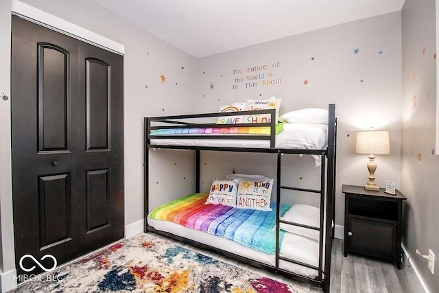 bedroom with baseboards and wood finished floors