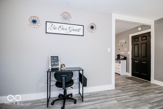 home office featuring baseboards and wood finished floors