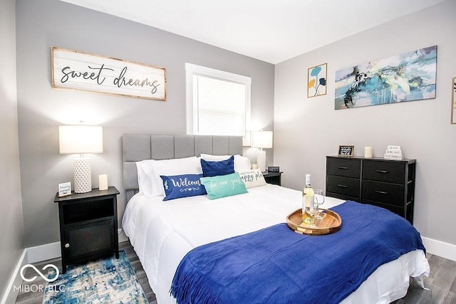 bedroom featuring baseboards and wood finished floors