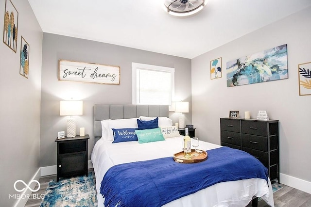 bedroom featuring baseboards and wood finished floors