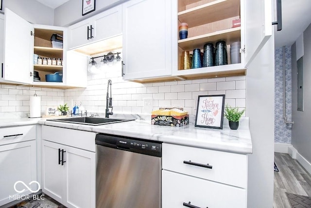 kitchen with tasteful backsplash, open shelves, dishwasher, a sink, and light wood-style flooring