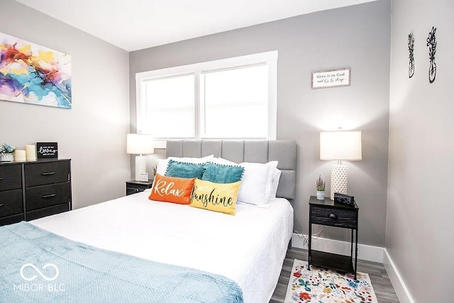 bedroom featuring baseboards and wood finished floors