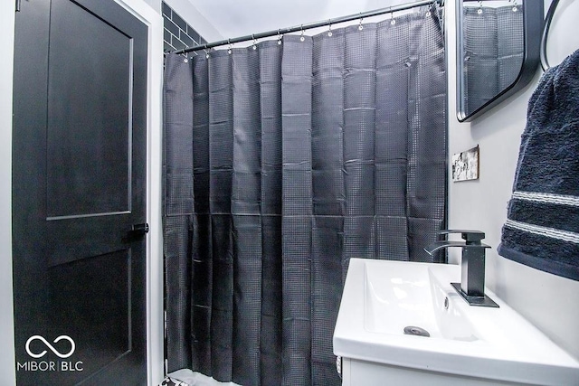 full bathroom with a sink and a shower with shower curtain