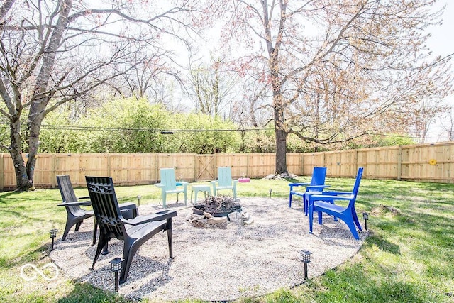 view of yard featuring a fenced backyard and an outdoor fire pit