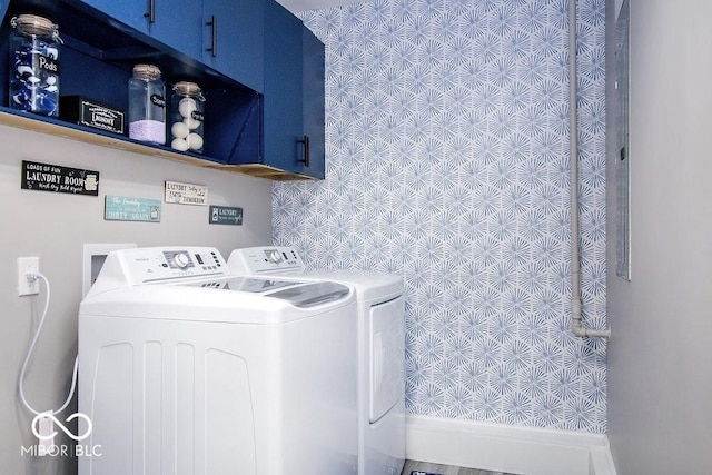 laundry room featuring washer and clothes dryer and cabinet space