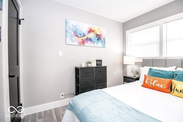 bedroom featuring baseboards and wood finished floors