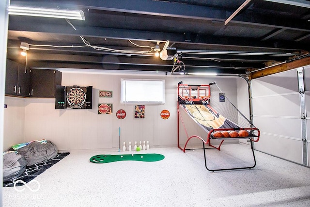 playroom featuring speckled floor and a garage
