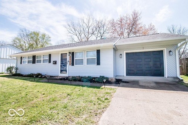 ranch-style home with a garage, driveway, and a front yard