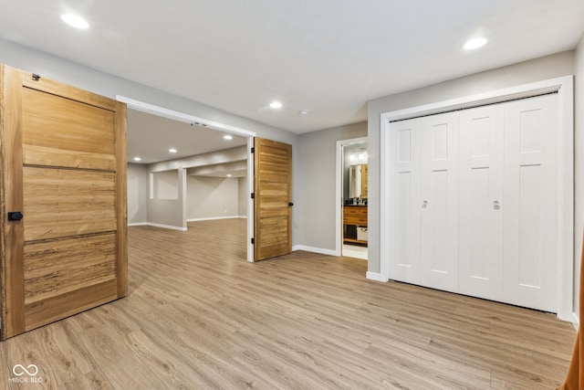 interior space featuring light wood-type flooring, recessed lighting, and baseboards