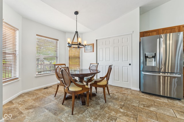 dining space with visible vents, vaulted ceiling, baseboards, a chandelier, and stone tile floors