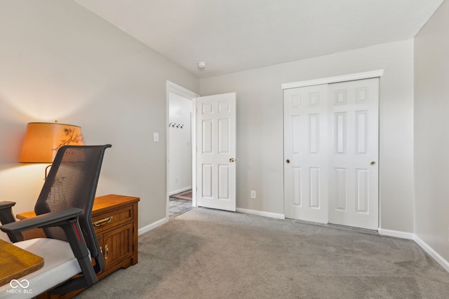 carpeted home office featuring baseboards