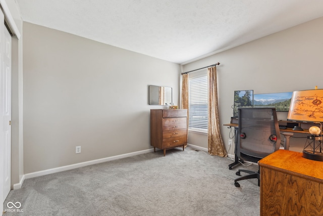 carpeted home office featuring baseboards