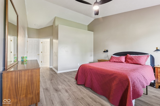 bedroom featuring baseboards, a ceiling fan, lofted ceiling, and wood finished floors
