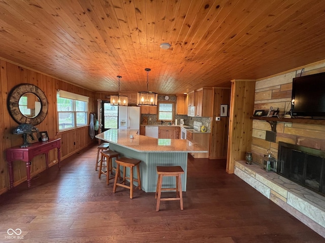 kitchen with wood walls, dark wood-style flooring, and white appliances