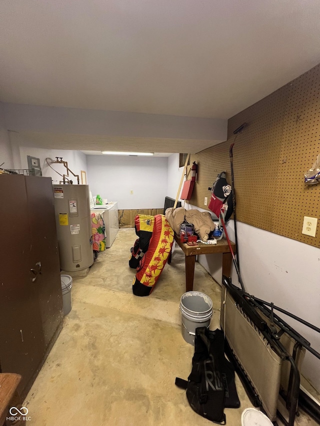 finished basement featuring water heater and washing machine and clothes dryer