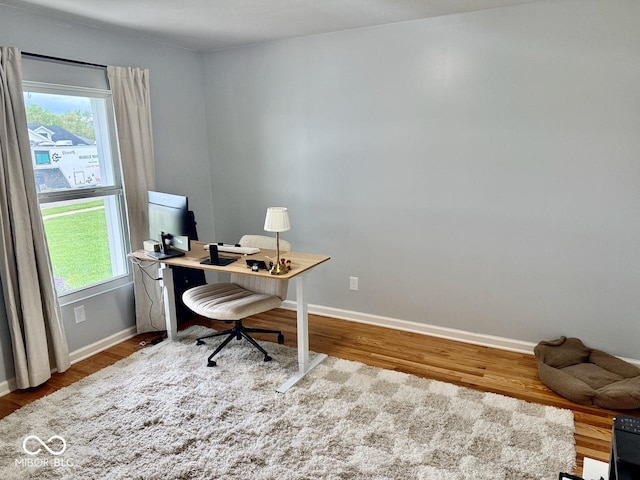 home office featuring baseboards and wood finished floors