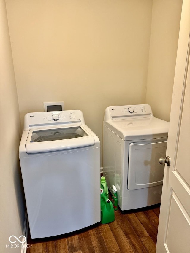 laundry room featuring laundry area, dark wood-style floors, and washing machine and clothes dryer