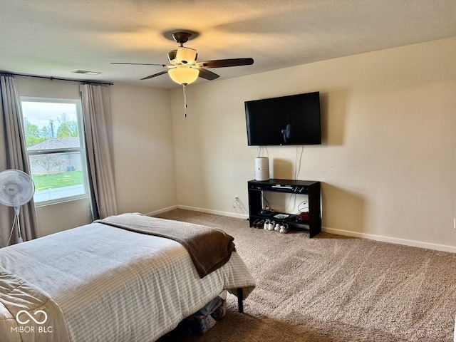 bedroom with carpet floors, a ceiling fan, baseboards, and visible vents