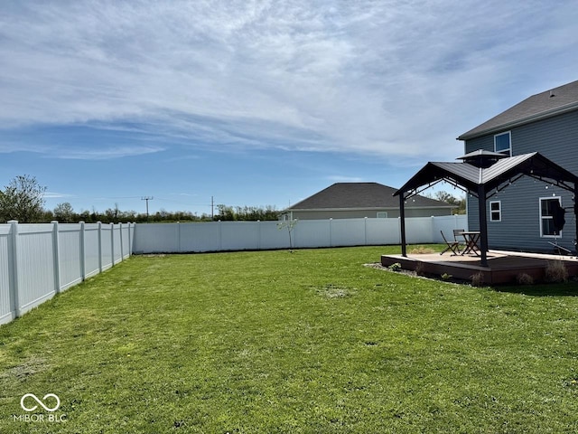 view of yard with a deck, a gazebo, and a fenced backyard