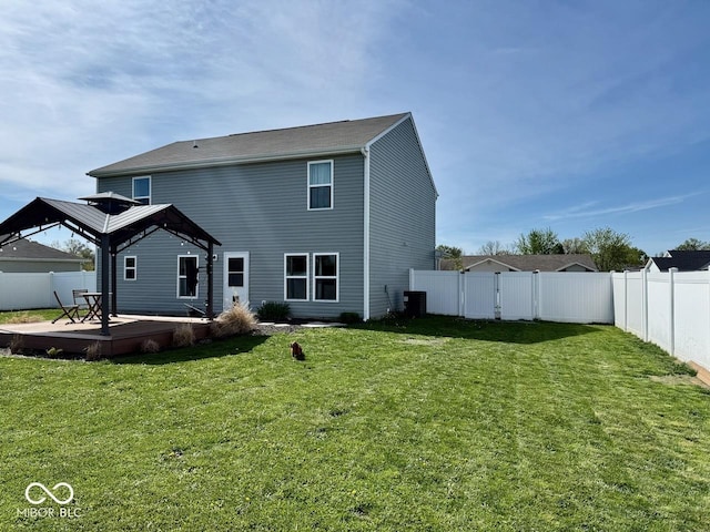 back of house with a lawn, a wooden deck, a fenced backyard, central AC unit, and a gazebo