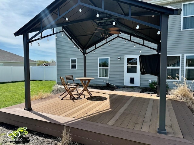 deck with a lawn and fence