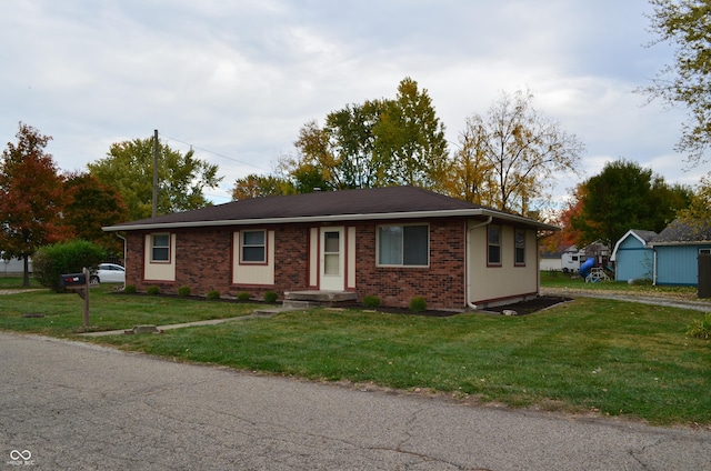 ranch-style home with brick siding and a front yard