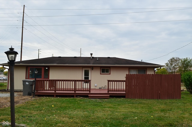 back of house with a yard and a deck