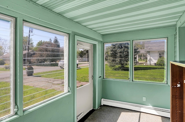 unfurnished sunroom featuring baseboard heating