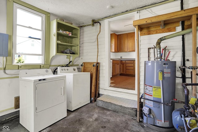 laundry area with laundry area, electric panel, a textured ceiling, water heater, and washer and clothes dryer