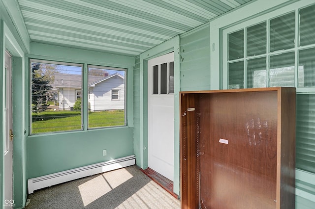 unfurnished sunroom featuring baseboard heating