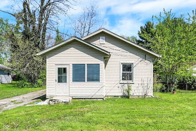 back of house with a lawn