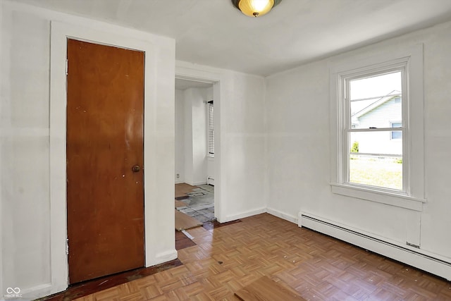 unfurnished room with baseboards, baseboard heating, and a baseboard radiator
